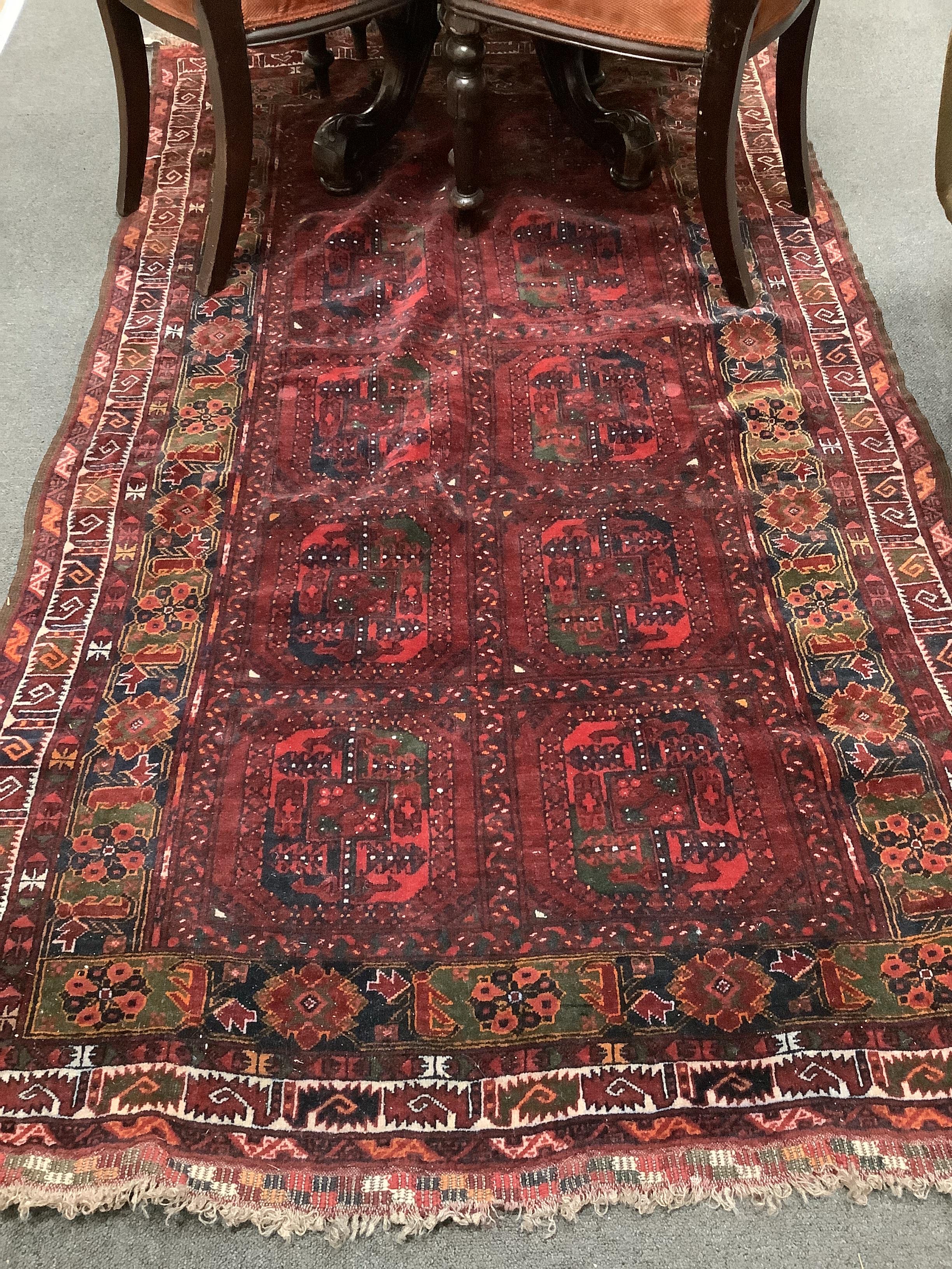 An Afghan red ground rug, 200 x 126cm